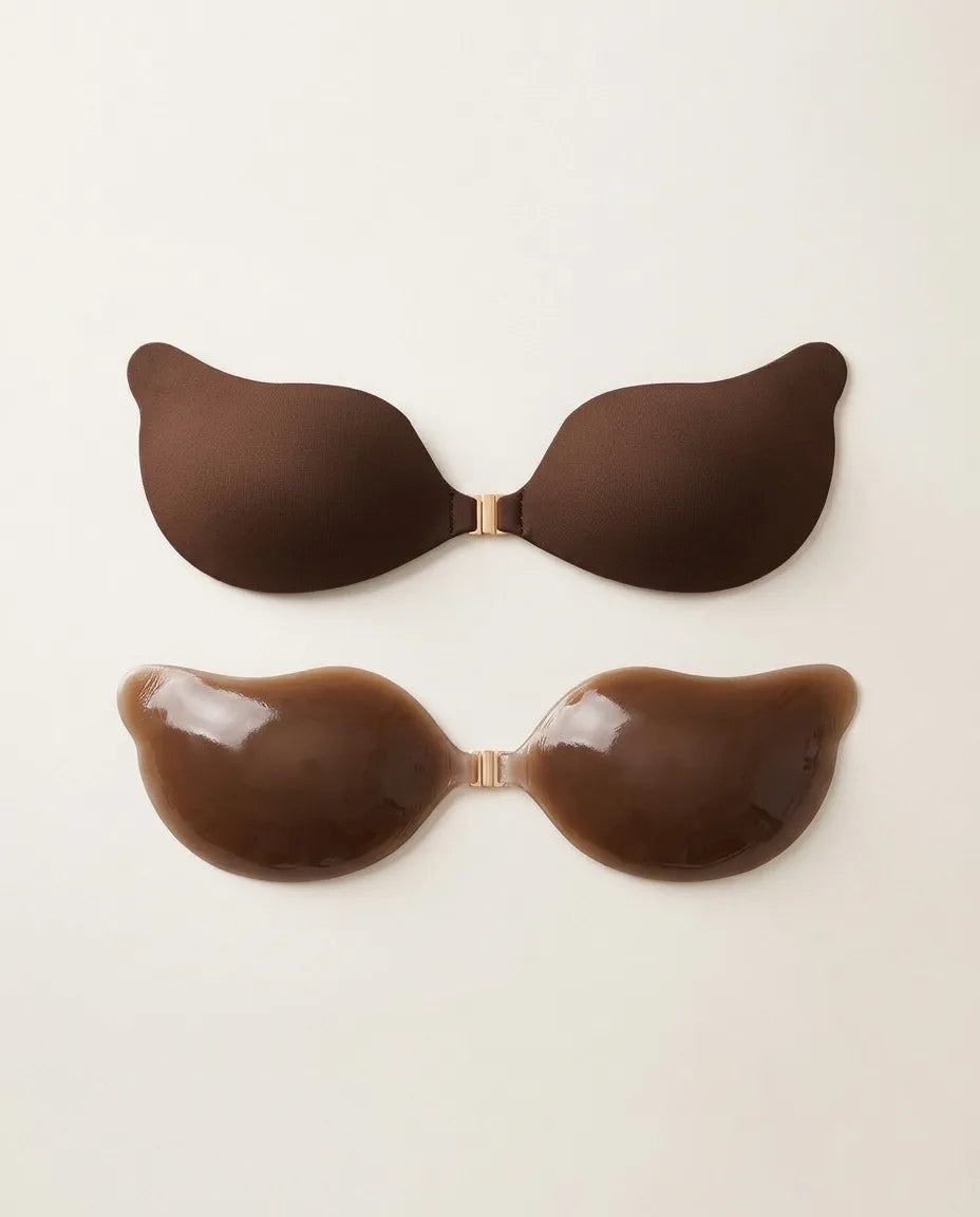 Two deep brown silicone adhesive bra cups shown from the outer fabric-look side and the glossy inner gel side
