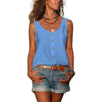 Close-up of the white singlet top's scoop neckline and button fastening with a tan belt and shorts