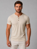 Front view of man wearing beige Henley T-shirt with button neck, styled with matching beige pants