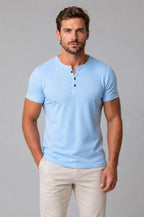 Front view of man wearing light blue Henley T-shirt with button placket and short sleeves