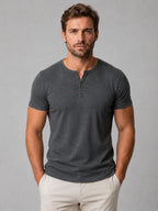 Front view of man wearing charcoal grey marle Henley T-shirt with button neckline and short sleeves
