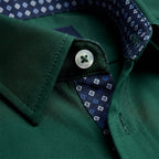 Front view of the dress shirt fastened with white buttons, showing the clean placket and slim silhouette