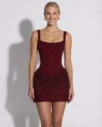 Front view of claret corset mini dress with square neckline and textured sequin skirt