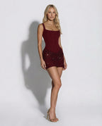 Side profile of claret corset mini dress showing sculpted hourglass silhouette