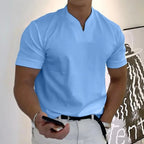 Light blue split-neck short sleeve polo shirt with ribbed cuffs and a chest pocket