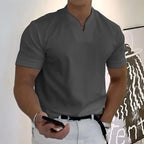 Close front view of a split-neck polo shirt showing the collarless notch neckline and pocket detail