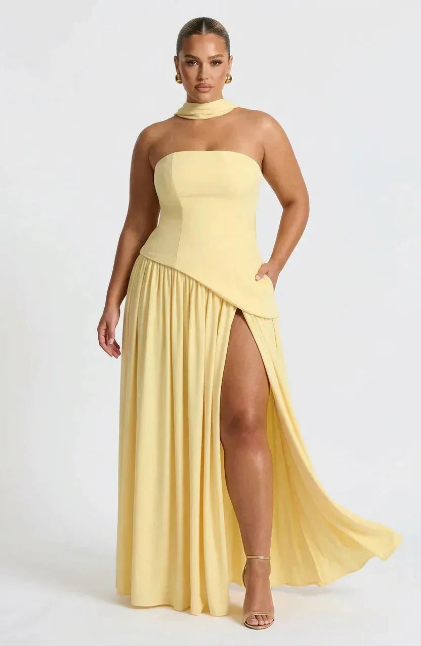 Front view of pale yellow strapless maxi dress with draped choker neckband and thigh-high slit