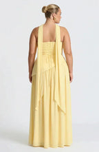 Back view of yellow maxi dress showing lace-up corset detail and long draped choker ties
