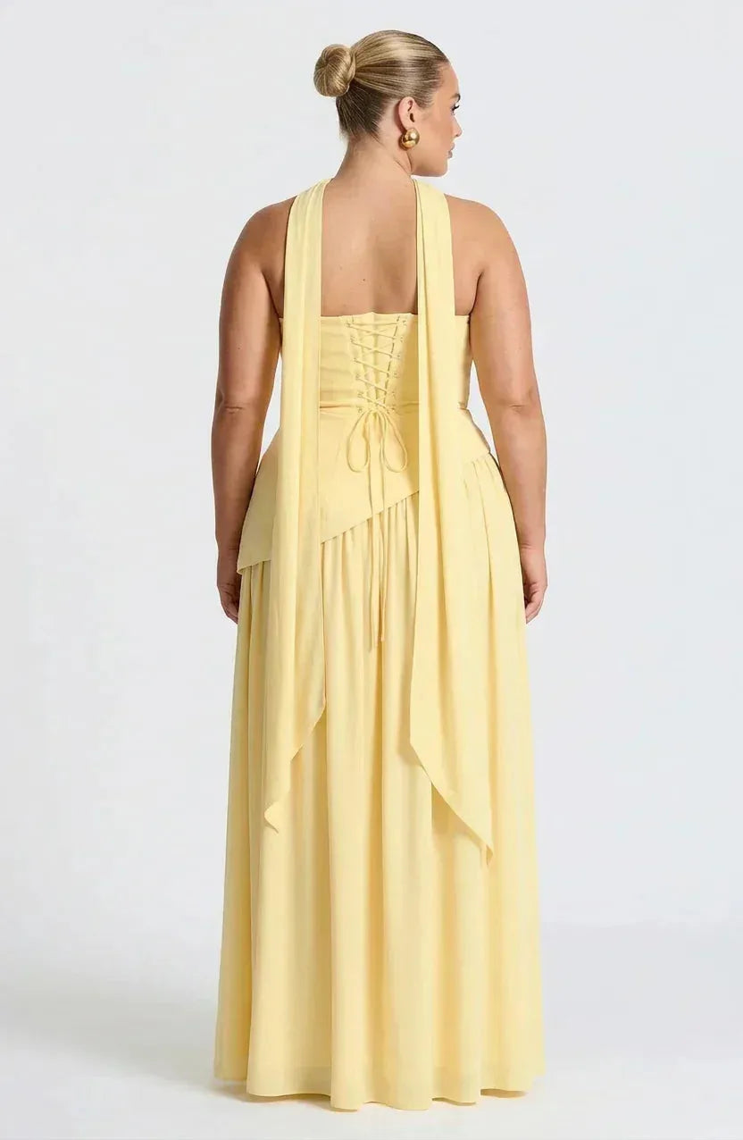Back view of yellow maxi dress showing lace-up corset detail and long draped choker ties