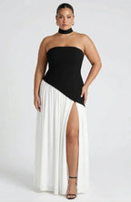 Front view of black and white colourblock strapless maxi dress with asymmetric drop waist and thigh slit