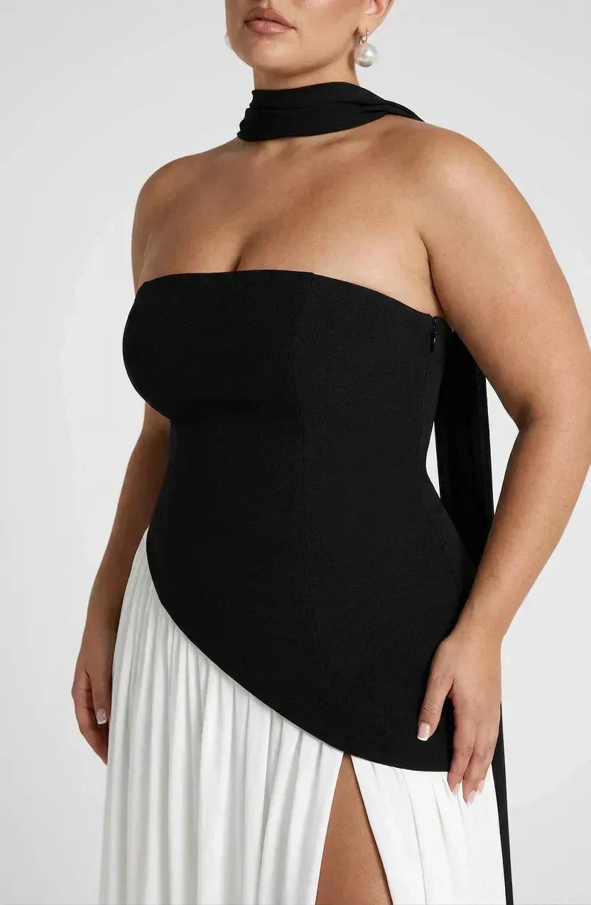 Close-up of black strapless bodice with draped choker neckband and asymmetric waist seam