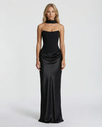 Front view of a strapless black corset gown with sweetheart neckline and sheer draped choker scarf