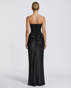 Back view showing the black corset's lace-up closure and the satin skirt's gathered drawstring detail