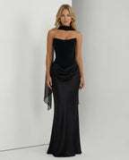 Three-quarter view of the black corset gown showing the sweetheart neckline and scarf drape