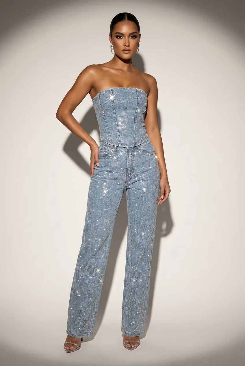 Front view of a strapless rhinestone-embellished denim corset top and straight-leg jeans two-piece in light blue