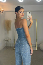 Rear view of the sparkling blue strapless corset and matching trousers, styled with a gold choker and bracelets
