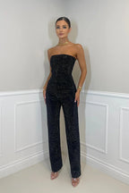 Full-length front view of the black glitter two-piece set paired with clear pointed-toe heels
