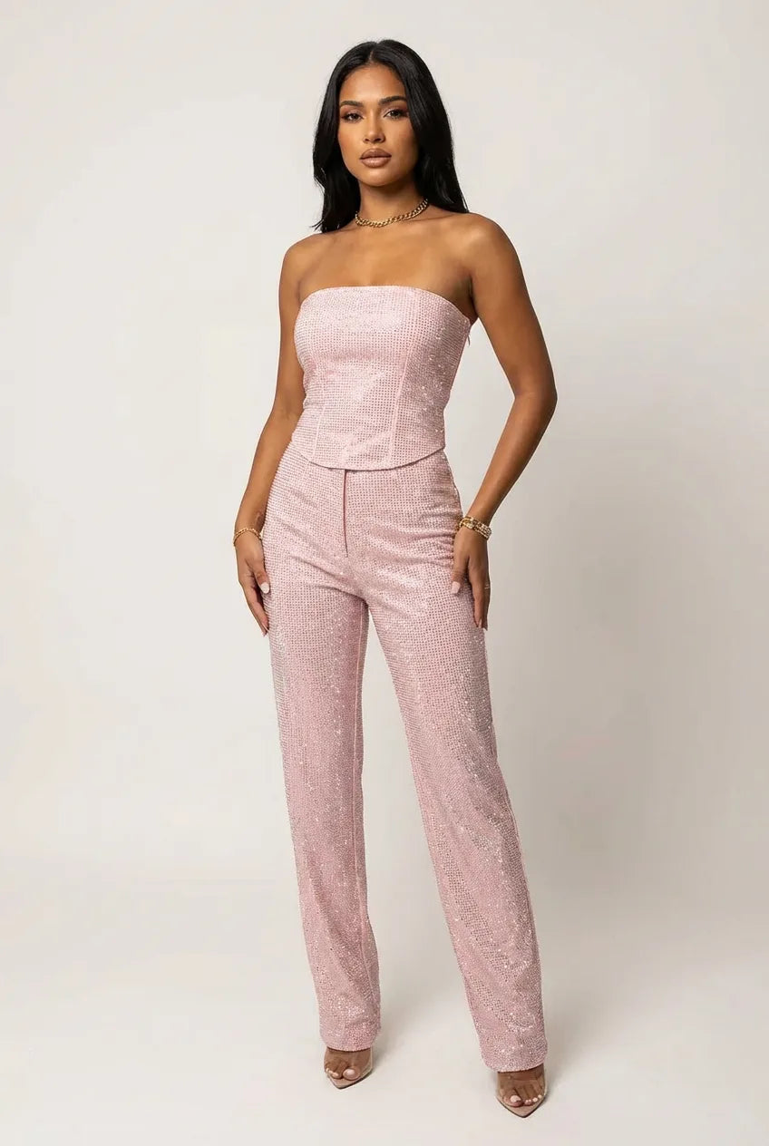 Front view of the light blue sparkling strapless corset top paired with wide-leg glitter trousers and clear strap heels