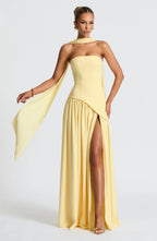 Front view of strapless yellow maxi gown with draped scarf, column bodice and gathered high-slit skirt