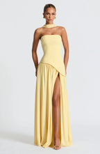 Full-length front view of yellow strapless gown with draped neck scarf and flowing asymmetrical skirt
