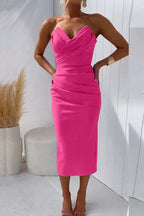 Three-quarter view of the strapless midi dress showing the pleated waist detail and below-knee length