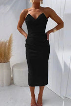 Full-length front view of strapless midi dress highlighting the ruched side seam and fitted skirt