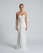 Front view of an ivory white strapless sequined corset gown with sheer boned bodice and long mermaid skirt