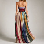 Back view showing the strapless straight neckline and flowing pleated multicolour skirt sweeping to the floor