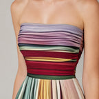 Close-up of the ruched strapless bodice showing the fine pleating and rich multicolour stripe pattern in burgundy, green, gold and lilac