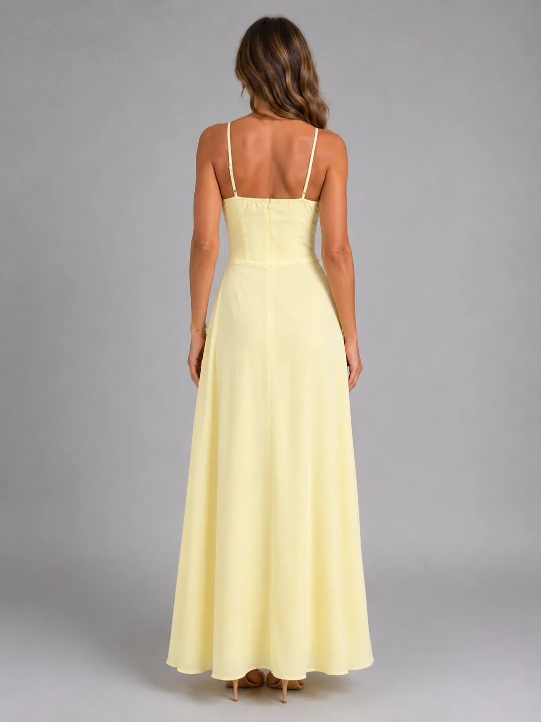 Back view of pale yellow maxi dress showing thin adjustable straps and flowing A-line skirt