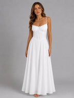Front view of model wearing the maxi dress in crisp white with fitted bodice and flared skirt
