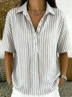 Taupe grey and white striped collared blouse with half-button front and silver cuff bracelet