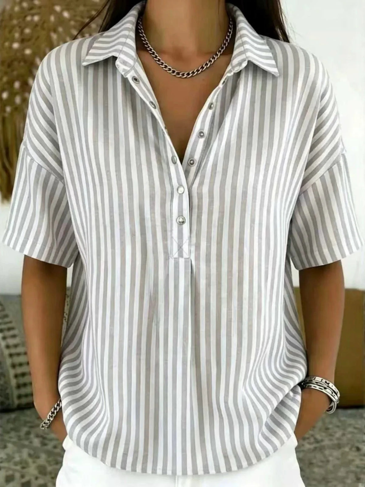 Taupe grey and white striped collared blouse with half-button front and silver cuff bracelet