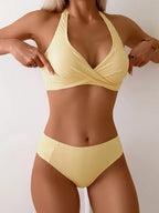 Front view of yellow pinstripe halter bikini set with twist-front top and high-waisted bikini bottoms