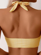 Back view close-up of yellow pinstripe bikini top showing the tie-back halter closure and knot detail