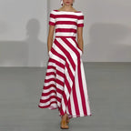 Model walks a runway in a red and white striped maxi dress with boat neckline, short sleeves and fitted bodice