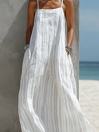 Close-up of the linen-look striped fabric and hand resting in the side pocket of the roomy maxi dress