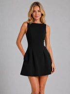 Front view of the same structured A-line mini dress in black, showing the sleeveless bodice and flared pleated skirt