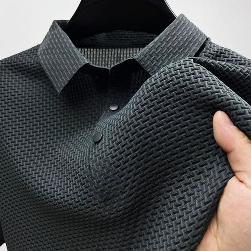 Close-up of a charcoal grey textured polo shirt on a hanger, showing the woven collar and button placket.