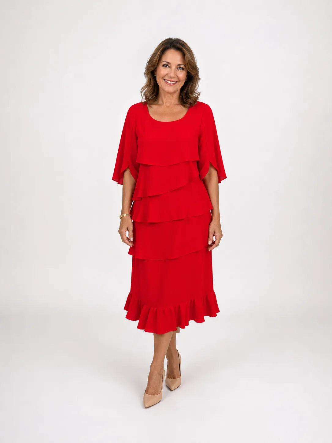 Front view of a woman in a red tiered ruffle midi dress with cape sleeves, paired with nude pointed heels