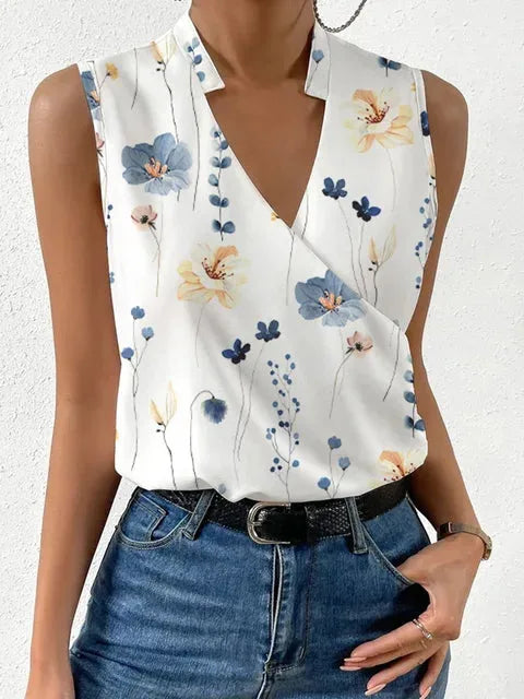 Sleeveless top in a blue and yellow wildflower print with a notched collar and crossover front panel