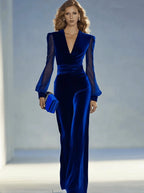 Close-up styled shot of the royal blue velvet jumpsuit showing the sculpted shoulders and sheer sleeve detail