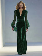 Front view of the jumpsuit in dark emerald green velvet with wide-leg pants and structured shoulders