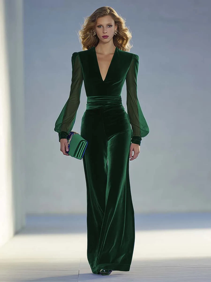 Front view of the jumpsuit in dark emerald green velvet with wide-leg pants and structured shoulders