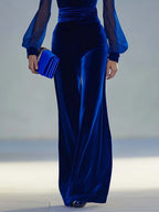 Detail shot of the royal blue velvet wide-leg pants and ruched waistband with matching clutch bag