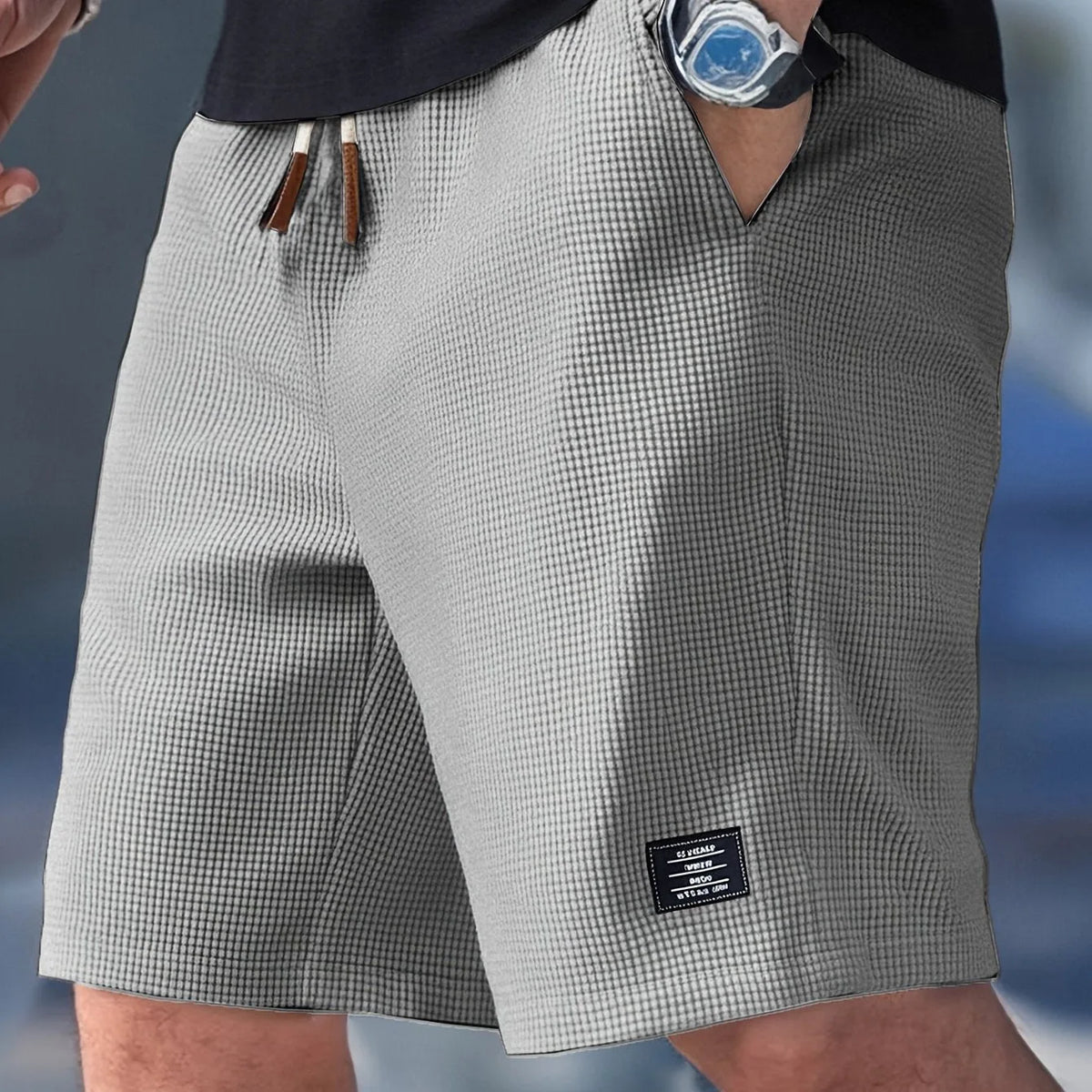 Light grey waffle-textured shorts with white drawcords and subtle side seam detailing