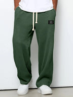 Light grey waffle-knit pants paired with white sneakers, full body front view