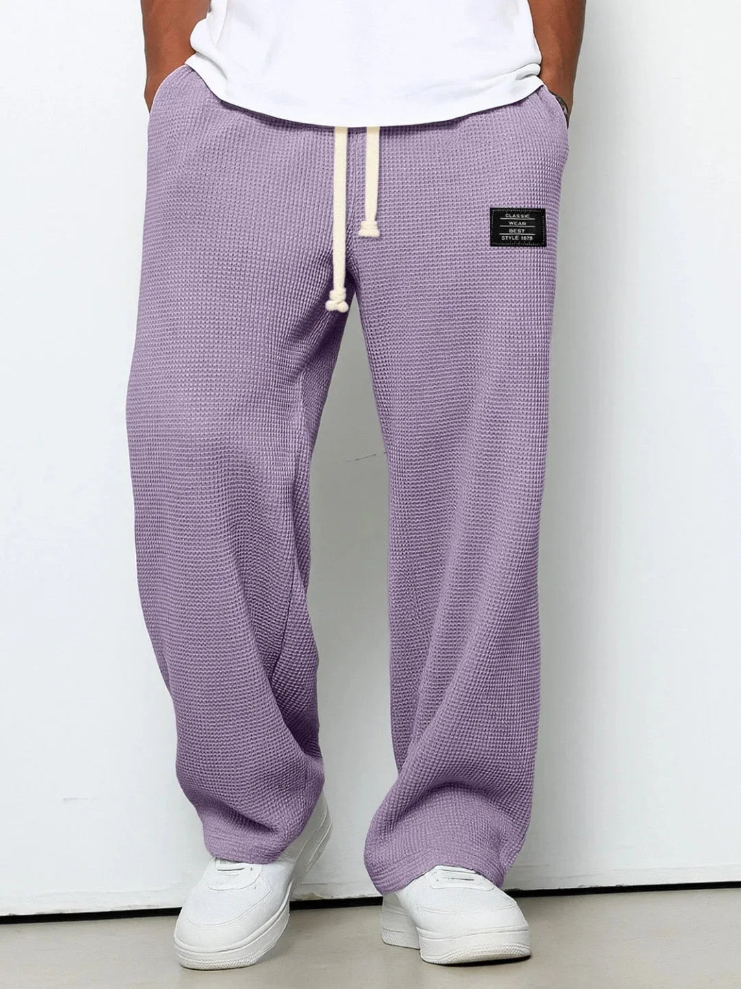 Dark khaki waffle-knit relaxed pants shown front-on highlighting textured fabric weave