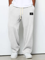 White waffle-knit relaxed pants worn with white sneakers, front view against plain backdrop
