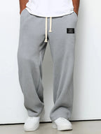 Light grey waffle-knit wide-leg pants shown from the front with cream drawstring tie